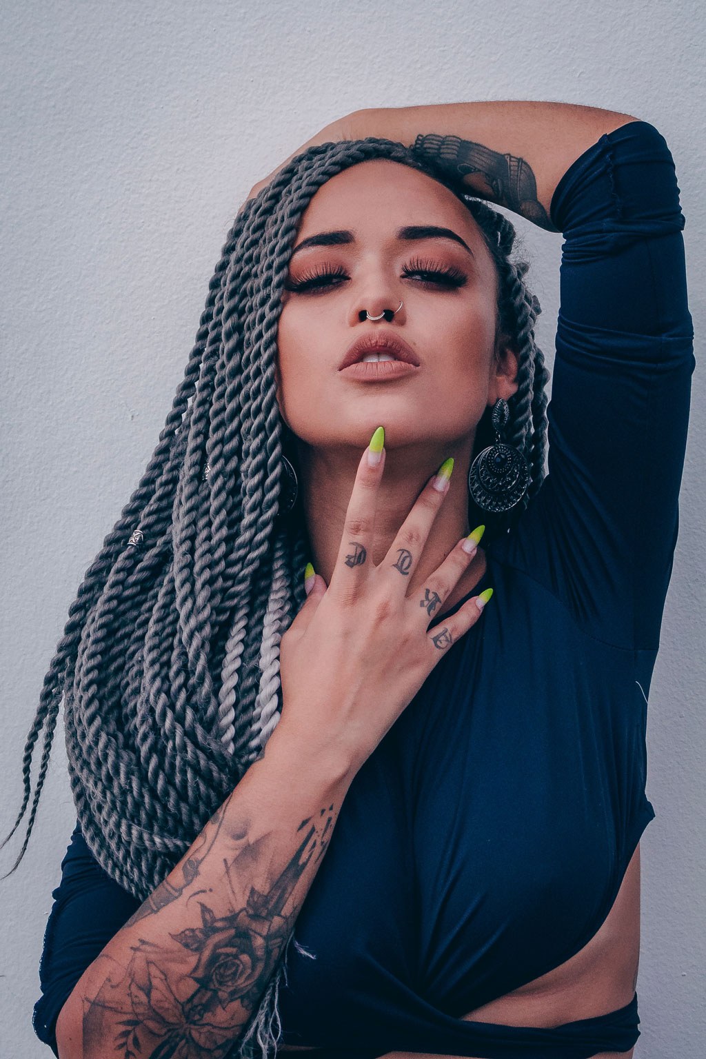 Latin woman in braids with makeup.