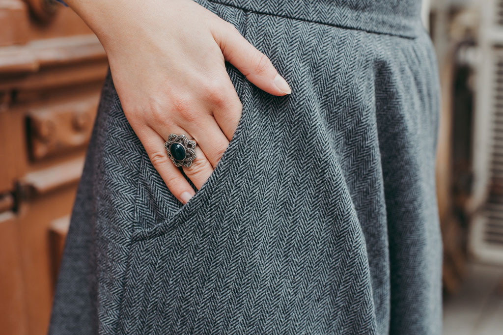 Woman's hand inside gray pants