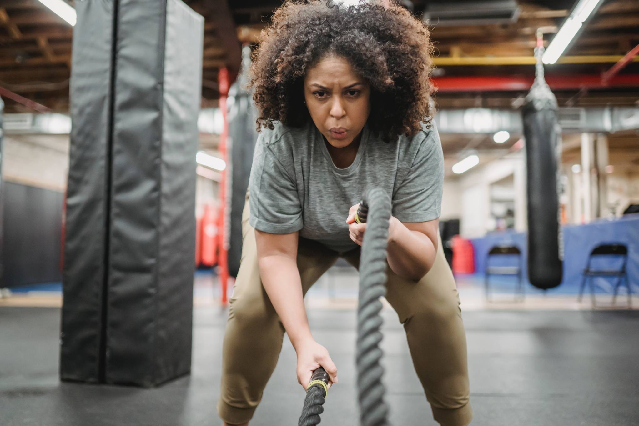 Woman training with ropes in a gym